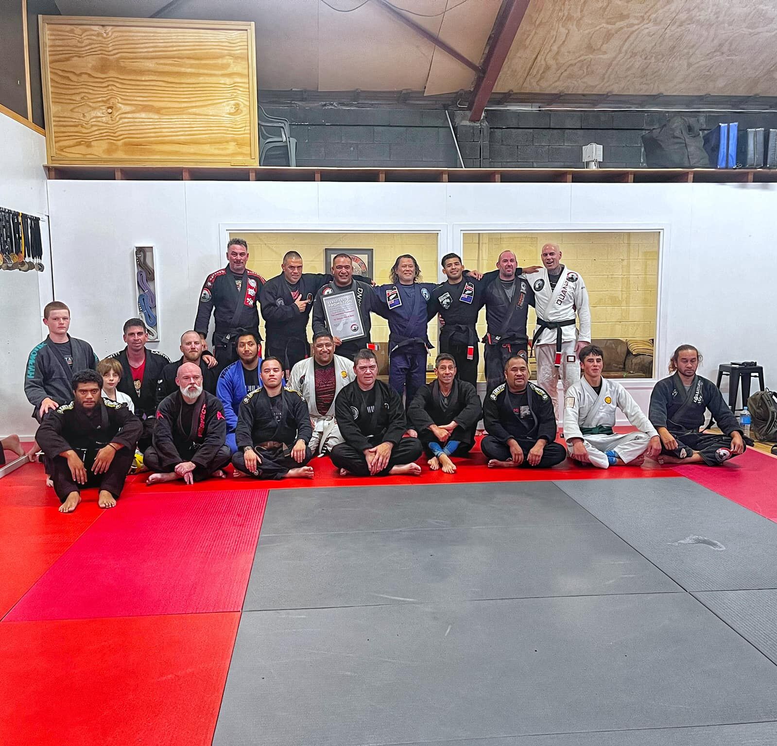 Tau's first-degree promotion seminar, with John Ouano presenting the certificate