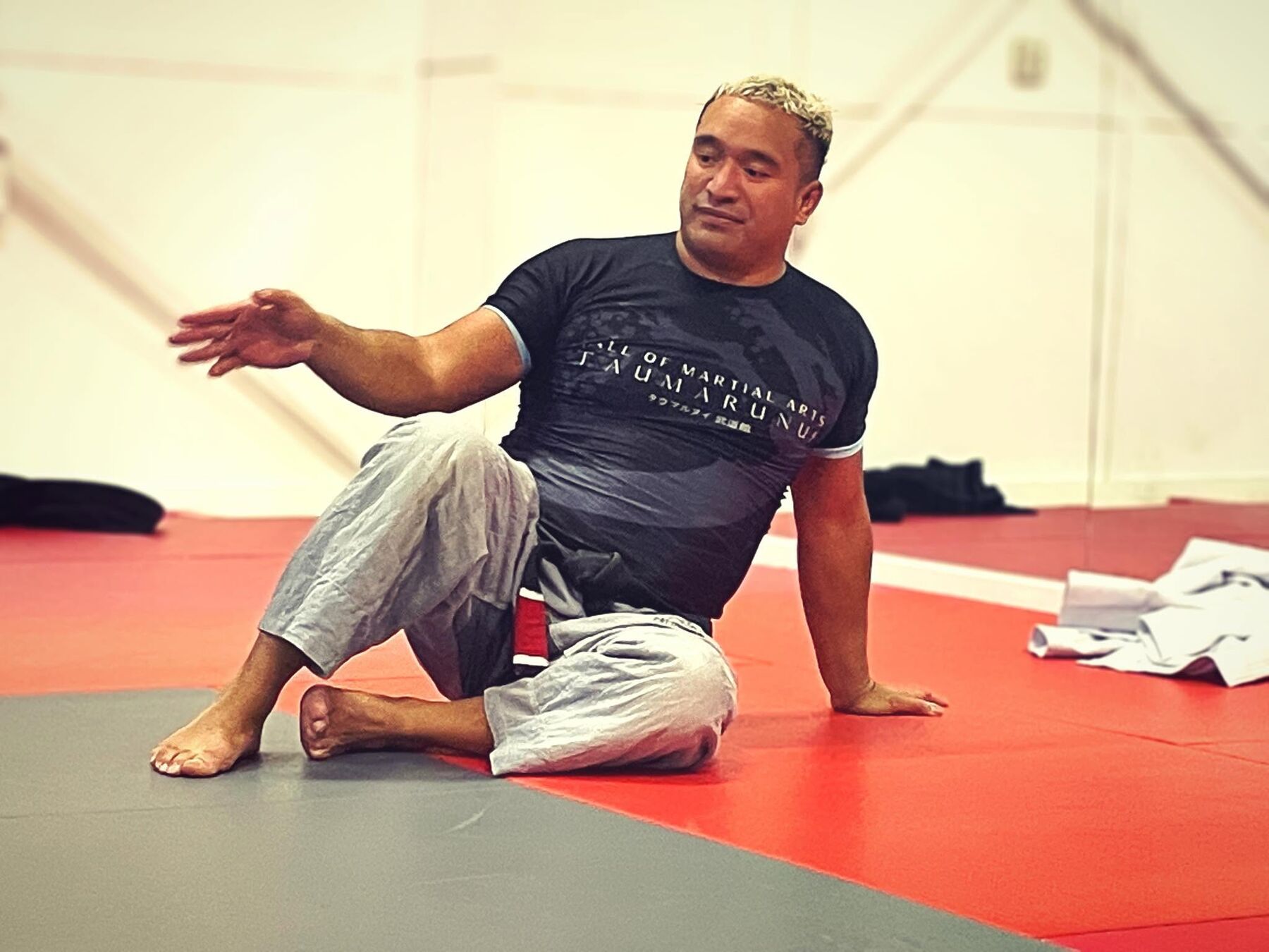 Coach Tau Thompson on the mats