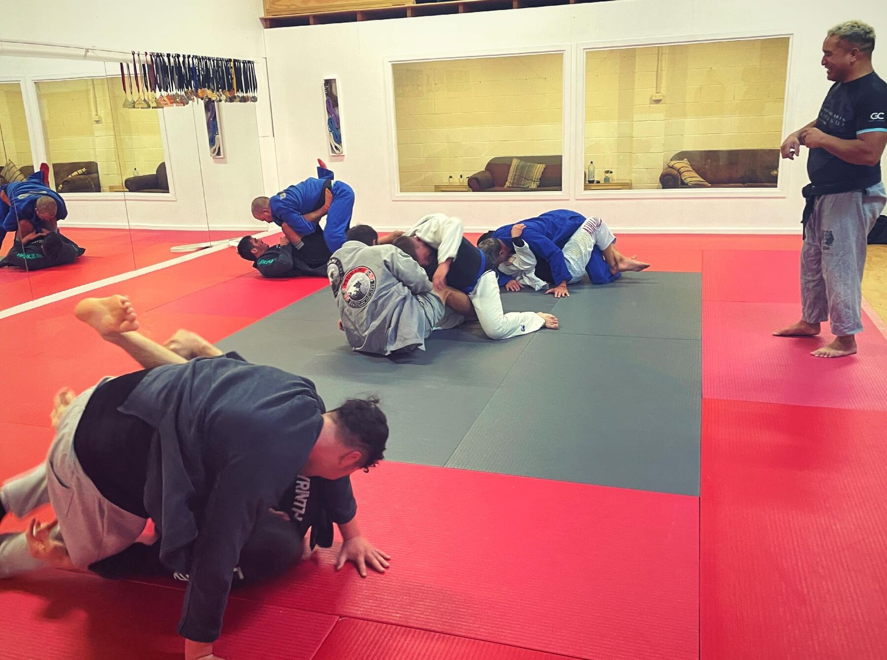 Coach Tau training on the mats